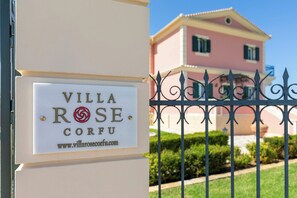 A sign for Villa Rose Corfu with a website URL.
