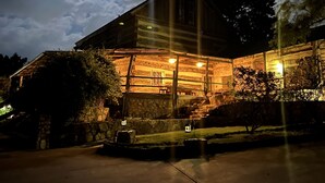 A rustic cabin with a stone foundation, wooden exterior, and a porch area. - Stay at these upscale, historic cabins set in New Braunfels near Guadalupe River (New Braunfels)