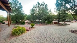 Stroll along the neatly manicured walkway surrounded by lush greenery.