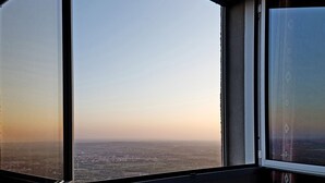 A large window with a view of a cityscape during daylight. - Villa Josephine: Above the vine yards overlooking the sea,  big terrasse & pool (Laroque-des-Albères)
