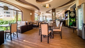 A modern restaurant with wooden flooring, curved ceiling, and large windows. - Step (Sunny Beach)
