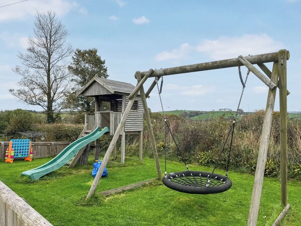 A playground with a swing set and a slide.