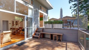 Relax on the spacious deck with a bench and table, offering a peaceful outdoor living space.