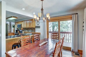Enjoy meals with family and friends at the large dining table in this well-equipped kitchen.