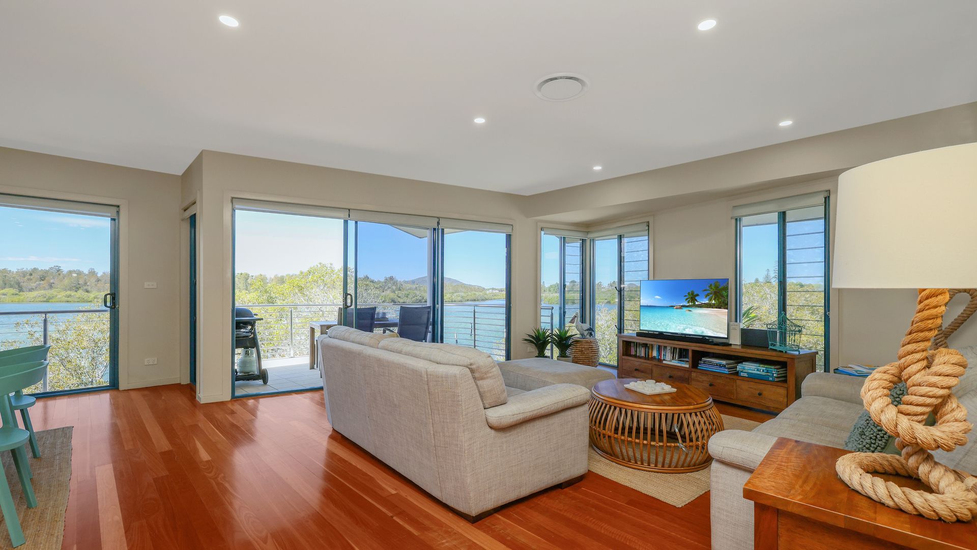 A spacious living room with a large sofa, a coffee table, and a television.
