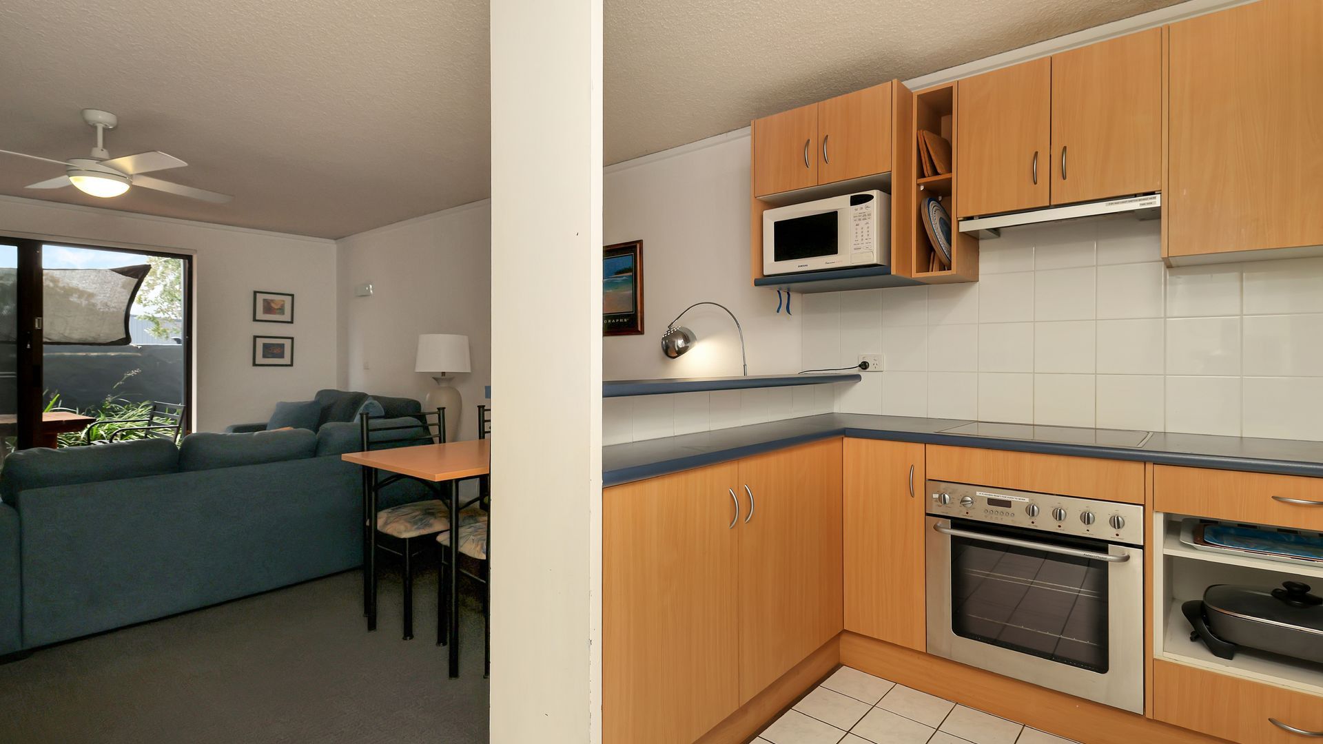 A compact living space with a kitchenette, a dining area, and a seating area.