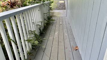 Guests can enjoy a serene outdoor space surrounded by lush greenery and a charming picket fence.