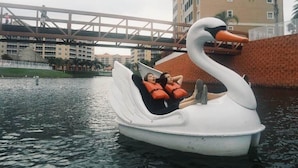 A swan-shaped boat with two people wearing life jackets. - Westgate Resort/luxury condo experience - 3 Bedroom Lock-off - Sleeps 12 (Kissimmee)