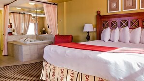 A hotel room with a large bed, a separate bathroom with a bathtub, and a canopy bed. - Westgate Resort/luxury condo experience - 3 Bedroom Lock-off - Sleeps 12 (Kissimmee)