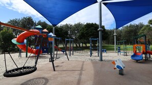 A playground with swings, slides, and climbing structures.