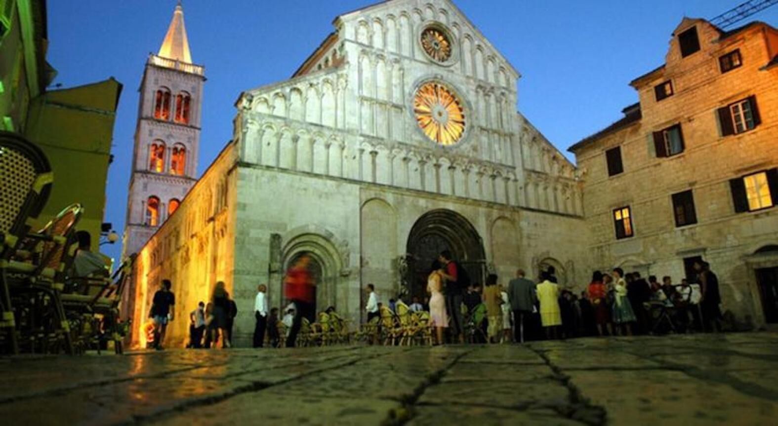 A historic building with a prominent clock tower and a large arched entrance.