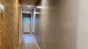 A hallway with wooden flooring and a grey wall. - New 2 Bed 2Bath Spacious Apartment w/Deck & Parking (Pittsburgh)
