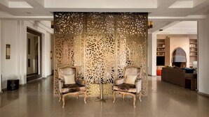 A lobby with two ornate chairs, a decorative screen, and a reception desk. - Private Modern Home 11 Rooms, Only 7min city centre (Marrakech)