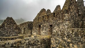 Ancient stone ruins with multiple conical structures and a central open area. - Choquequirao Sanctuary Lodge (Santa Teresa)