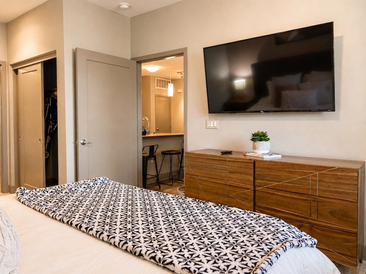 Restful bedroom with a smart TV, dresser and closet