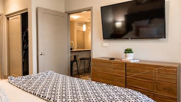 Restful bedroom with a smart TV, dresser and closet