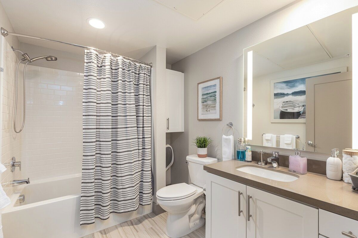 Une salle de bain moderne équipée d’une douche, de toilettes et d’un lavabo.