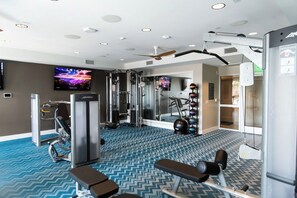 Spacious fitness center with weight machines, cardio equipment and TVs - Resort-Style 2bed Condo 3 Miles to Disney (Fullerton)