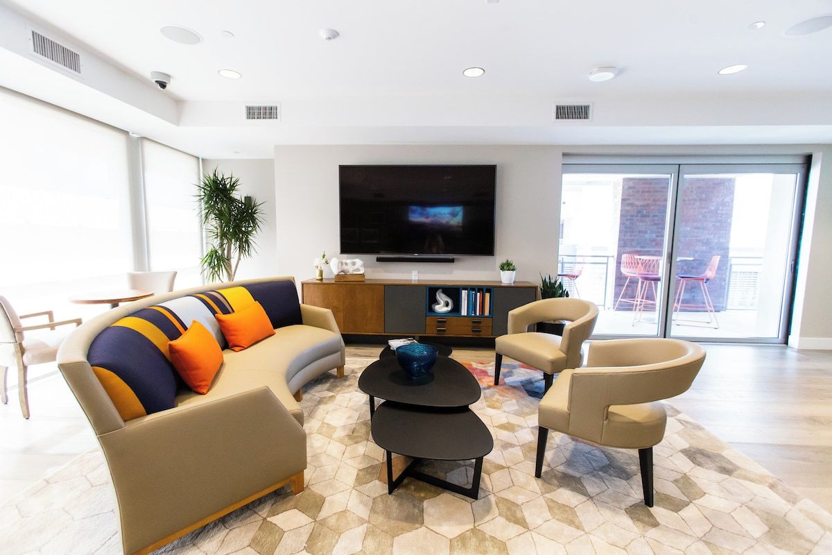 Bright community lounge with cozy seating and a TV