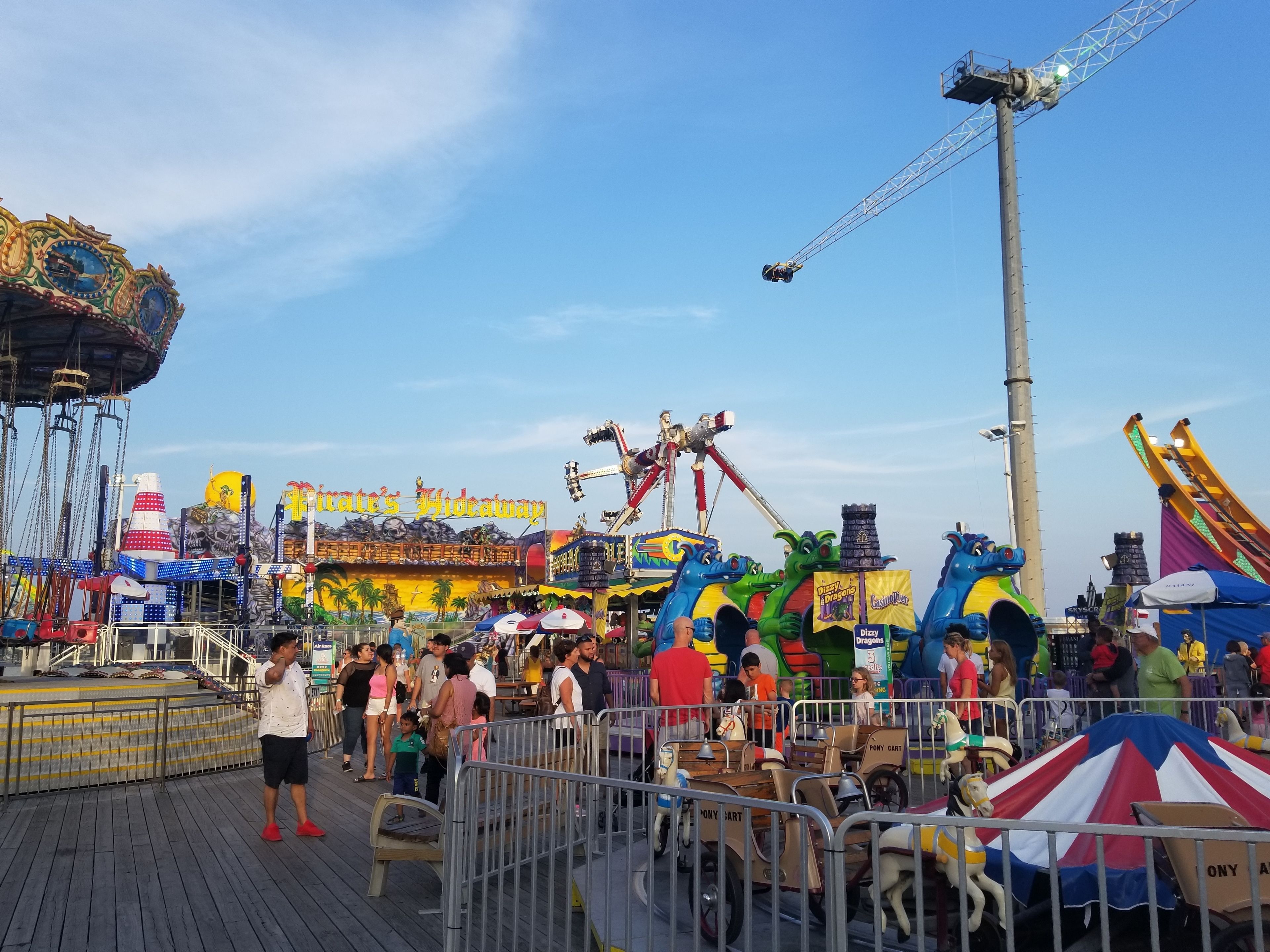 A bustling amusement park with various rides and attractions.