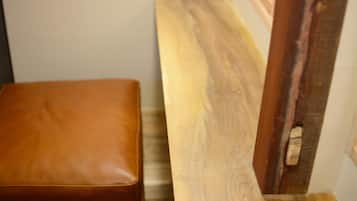 A wooden bench with a leather seat and a wooden table.
