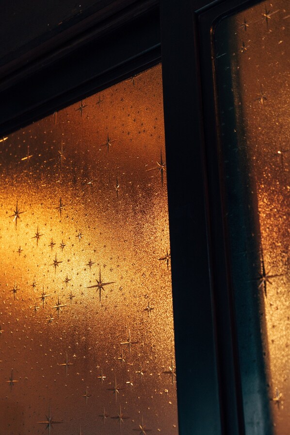 A window with a textured surface and star-shaped patterns.
