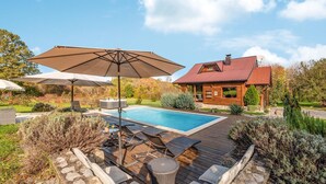 A wooden house with a red roof, a swimming pool, and outdoor furniture. - Lovely home in Gospic (Gospic)