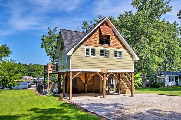 A two-story house with a covered porch and a garage.