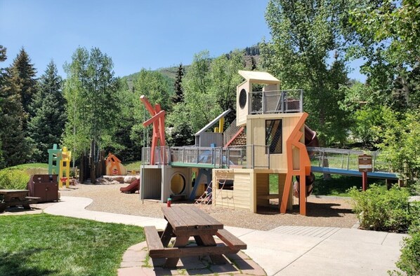 Kids can play on the slide, climb and explore the playhouse and climbing elements in this outdoor playground.