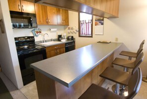 Enjoy cooking and dining in this well-equipped kitchen with a central island and bar seating.