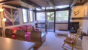 A cozy living room with a sofa, chairs, a dining table, and a fireplace. - Vail Studio Condo Private Balcony, Loft, HSB312 (Vail)