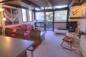 Cozy living space with a comfortable seating area, dining table, and fireplace.