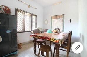 Enjoy meals with family and friends at the dining table, surrounded by comfortable chairs.