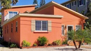 A single-story house with a flat roof, a central window with shutters, and a small porch area. - Dix-Sea-Land Delight: Close to beach, private pool, quiet street (Bradenton Beach)
