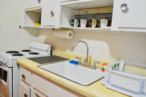 A kitchen with a stove, sink, and cabinets. - Design Studio/Sleeps 6/East Hollywood/BBQ/2 miles to beach/Free Parking/7 (Hollywood)