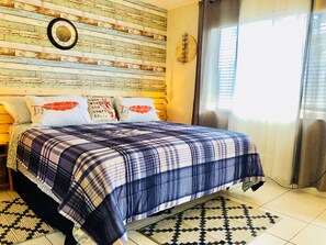 A bedroom with a bed, pillows, a clock, and a window with curtains. - Nice studio/East Hollywood/ Sleeps 4/BBQ/2 miles to beach/free parking/6 (Hollywood)