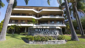 A multi-story building with a sign reading "Wallis Court." - Newly Renovated Unit near Forster Main Beach! (Forster)