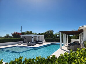 A swimming pool with lounge chairs and a covered seating area. - 10% off nightly rate Promo for stay: Aug 10 to Nov 10 2026
Private Villa & Pool (Long Bay)