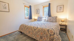 A bedroom with a large bed, two bedside lamps, and framed botanical prints on the walls. - June Lake Lodge- Centrally located - short walk to JLB, The General Store, both Gull and June Lakes (June Lake)