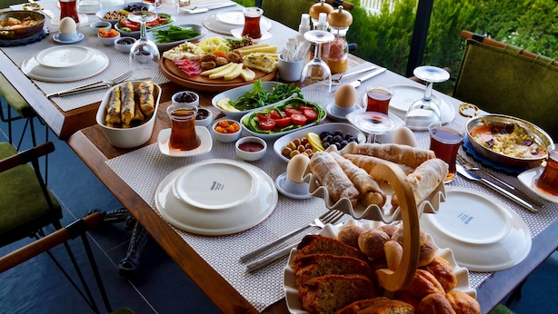 A table set for a meal with various dishes, glasses, and utensils.