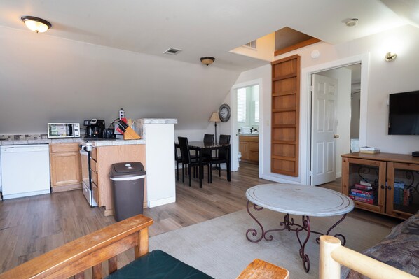 A compact living space with a kitchen, dining area, and a small seating area.