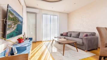 Apartment, 1 Bedroom | Living area | 125-cm Smart TV with cable channels