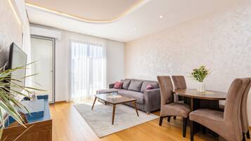 Apartment, 1 Bedroom | Living area | 125-cm Smart TV with cable channels