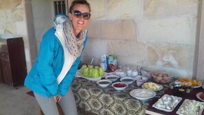 Une table dressée avec divers aliments et boissons, notamment des bols remplis de nourriture, des tasses et un carton de lait.