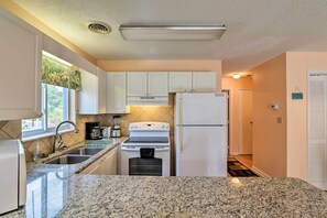 Enjoy cooking in this well-equipped kitchen with an oven, stainless steel sink, and modern appliances.