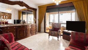 A spacious living room with a large TV, a fireplace, and a comfortable sofa. - Home2Book Spacious Classic Design Apto SC Center (Santa Cruz de Tenerife)