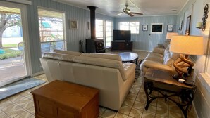 A living room with a beige sofa, a wooden coffee table, and a television.