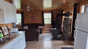 A cozy cabin interior with a kitchen, dining area, and living room.