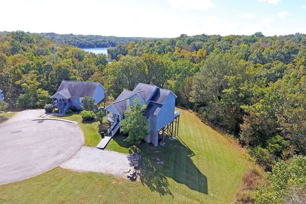 A large house with a garage, a driveway, and a well-maintained lawn.