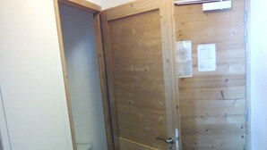 A wooden door leading to a bathroom with a toilet visible through an open doorway. - Superb 6-person apartment at the foot of the slopes, in the "Coeur des Loges" residence (Les Menuires)
